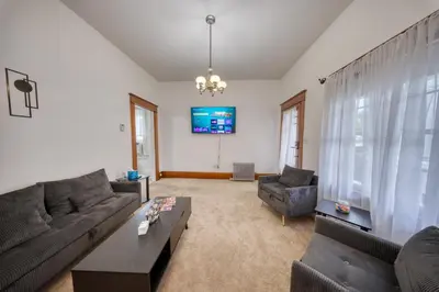 a living room with a couch and a tv at Charming 2-Bedroom, 1-Bath Getaway in Carbondale