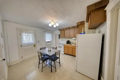 a kitchen with a table and a white refrigerator at Charming 2-Bedroom, 1-Bath Getaway in Carbondale