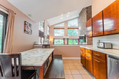 a kitchen with a table and some windows at Switch to hosting Peaceful Lakefront Stay, HotTub, Fireplace, Kayaks in East Stroudsburg