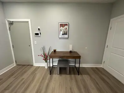 a room with a table with a candle and a door at Chic New Apt in Heart of Philly in Philadelphia