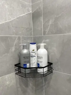 three bottles of cleaning products sit on a shelf in a bathroom at Chic New Apt in Heart of Philly in Philadelphia