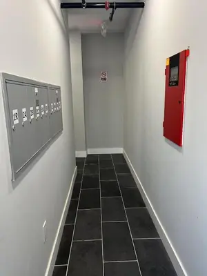 a hallway with a red door and a tiled floor at Chic New Apt in Heart of Philly in Philadelphia