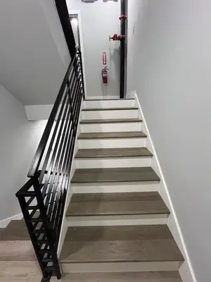 a staircase in a building with white walls at Chic New Apt in Heart of Philly in Philadelphia