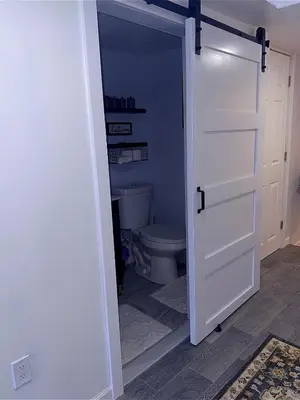 a bathroom with a toilet and a white door at Philly Stay by TJ in Philadelphia