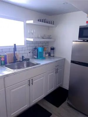 a kitchen with a sink and a refrigerator at Philly Stay by TJ in Philadelphia