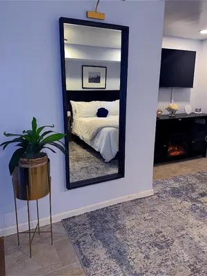 a mirror on a wall in a bedroom with a bed at Philly Stay by TJ in Philadelphia