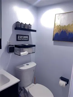 a bathroom with a white toilet and a sink at Philly Stay by TJ in Philadelphia
