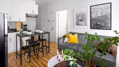 a kitchen and living room with a couch and a table at Spacious 3BR Retreat Near Times Square in New York