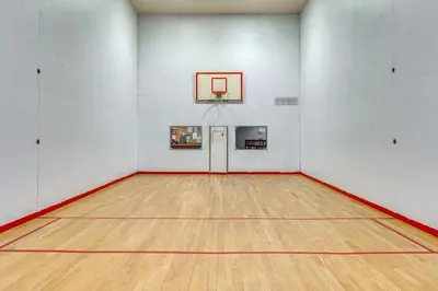 an empty gym with a basketball hoop on the wall at Beech Mt Lakefront Gem! Hot Tub, Kayaks, Billiards