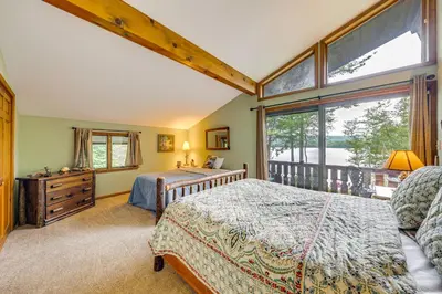 a bedroom with a bed and a large window at Beech Mt Lakefront Gem! Hot Tub, Kayaks, Billiards