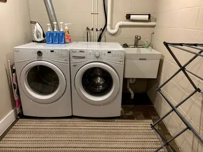 a washing machine in a bathroom with a sink at Fantastic A-Frame Cabin for a Couples' Getaway near Robesonia, Pennsylvania in Robesonia