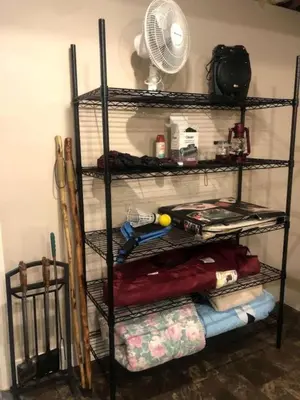 a shelf with a fan and other items on it at Fantastic A-Frame Cabin for a Couples' Getaway near Robesonia, Pennsylvania in Robesonia