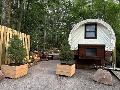 a dome tent with a piano in a yard at Elegant, Vintage Conestoga Covered Wagon Getaway in Denver, Pennsylvania in Denver