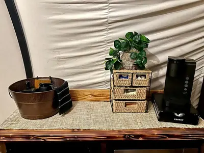 a table with a potted plant on top at Elegant, Vintage Conestoga Covered Wagon Getaway in Denver, Pennsylvania in Denver