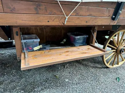 a wooden wagon with a wooden wheel on the ground at Elegant, Vintage Conestoga Covered Wagon Getaway in Denver, Pennsylvania in Denver