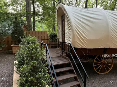 a yurt with a staircase leading up to a porch at Elegant, Vintage Conestoga Covered Wagon Getaway in Denver, Pennsylvania in Denver
