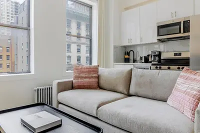 a living room with a couch and a table at Blueground Midtown West washerdryer nr Central Park NYC-1876 in New York