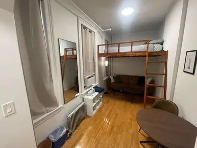 a small room with a bunk bed and a desk at Renovated Studio in Union Square in New York