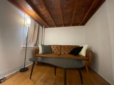 a living room with a couch and a lamp at Renovated Studio in Union Square in New York