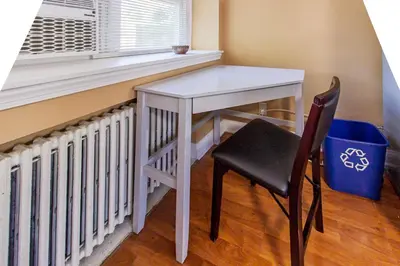 a white table and a chair next to a window at Comfy 1 BR Hide Away Apt w Garage Parking in Bryn Mawr