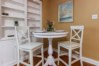 a white table and two chairs in a room at Comfy 1 BR Hide Away Apt w Garage Parking in Bryn Mawr