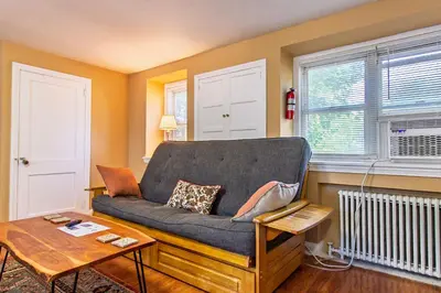 a living room with a couch and a table at Comfy 1 BR Hide Away Apt w Garage Parking in Bryn Mawr