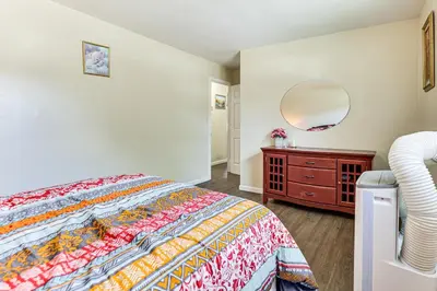 a bedroom with a bed and a dresser and a mirror at 2 Mi to The Marketplace Spring Valley Apartment in Spring Valley