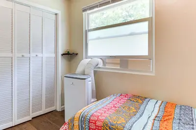 a bedroom with a bed and a window and a radiator at 2 Mi to The Marketplace Spring Valley Apartment in Spring Valley