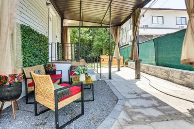 a patio with chairs and tables and a fence at 2 Mi to The Marketplace Spring Valley Apartment in Spring Valley