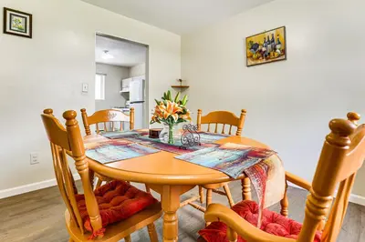 a dining room with a wooden table and chairs at 2 Mi to The Marketplace Spring Valley Apartment in Spring Valley