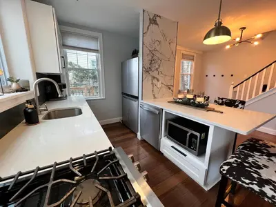a kitchen with a sink and a counter top at Cozy Cabin On the Lake with HotTub in Hopatcong