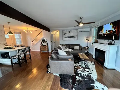 a living room with a couch and a tv at Cozy Cabin On the Lake with HotTub in Hopatcong