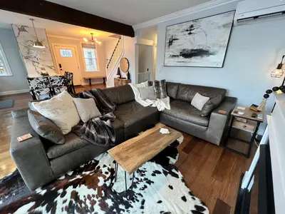 a living room with a couch and a table at Cozy Cabin On the Lake with HotTub in Hopatcong