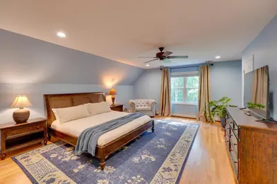 a bedroom with a bed and a television in it at Creek Dips and Smores Catskills Gem