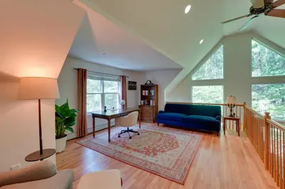 a living room with a blue couch and a table at Creek Dips and Smores Catskills Gem