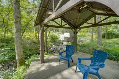 two blue chairs sitting under a gazebo at Creek Dips and Smores Catskills Gem