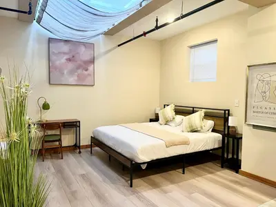 a bedroom with a bed and a table at Skylight studio Rittenhouse philadelphia in Philadelphia