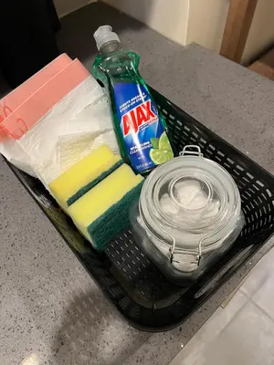a basket with a bottle of laundry detergent and a dish towel at Skylight studio Rittenhouse philadelphia in Philadelphia