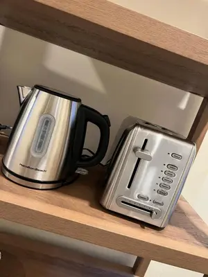 a coffee pot and toaster sitting on a shelf at Skylight studio Rittenhouse philadelphia in Philadelphia
