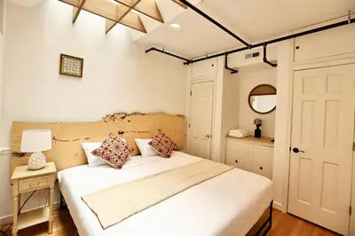 a bedroom with a large white bed and a mirror at Urban Luxe Redefined in Central city Phila in Philadelphia