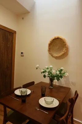 a wooden table with two plates and flowers on it at Urban Luxe Redefined in Central city Phila in Philadelphia