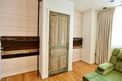 an old door in a room with a green chair at Urban Luxe Redefined in Central city Phila in Philadelphia