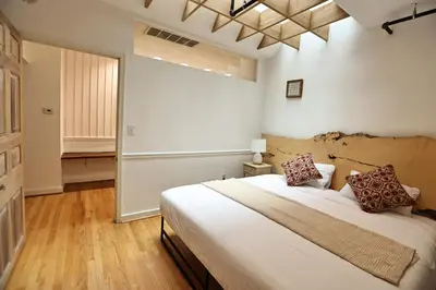 a bedroom with a large white bed with two pillows at Urban Luxe Redefined in Central city Phila in Philadelphia