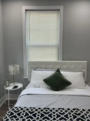 a bedroom with a bed with a large window at New 1BR Walk to Pats & Genos in Philadelphia