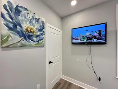 a room with a tv hanging on the wall at New 1BR Walk to Pats & Genos in Philadelphia
