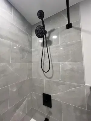 a shower with a shower head in a bathroom at New 1BR Walk to Pats & Genos in Philadelphia