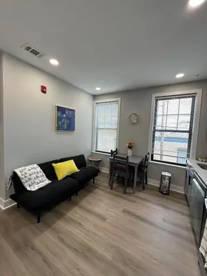 a living room with a couch and a table at New 1BR Walk to Pats & Genos in Philadelphia