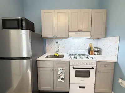a kitchen with a stove and a sink and a refrigerator at New York City Dreams - 10 Mins in Union City