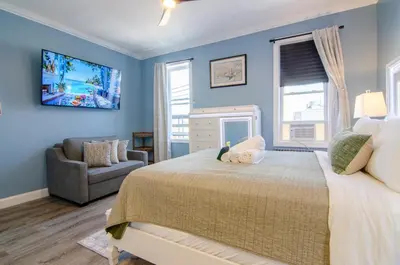 a bedroom with blue walls and a bed with a stuffed animal on it at New York City Dreams - 10 Mins in Union City