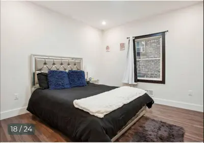 a bedroom with a large bed with blue pillows at Contemporary Luxury 3 Bdr Apt for 6 with Free Parking in Jersey City